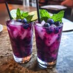 If you’re looking for a refreshing and vibrant drink that’s perfect for any occasion, the Blueberry Basil Lemon Lavender Mocktail is the way to go. This non-alcoholic drink combines the sweet and tart flavors of fresh blueberries with the earthy taste of basil, a touch of floral lavender, and the zesty kick of lemon. It’s the ultimate drink to wow your guests while keeping things light and refreshing.