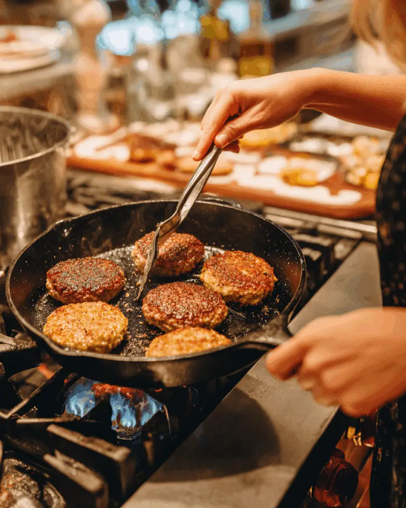 Cooking Homemade Maple Chicken Sausage Patties in cast iron