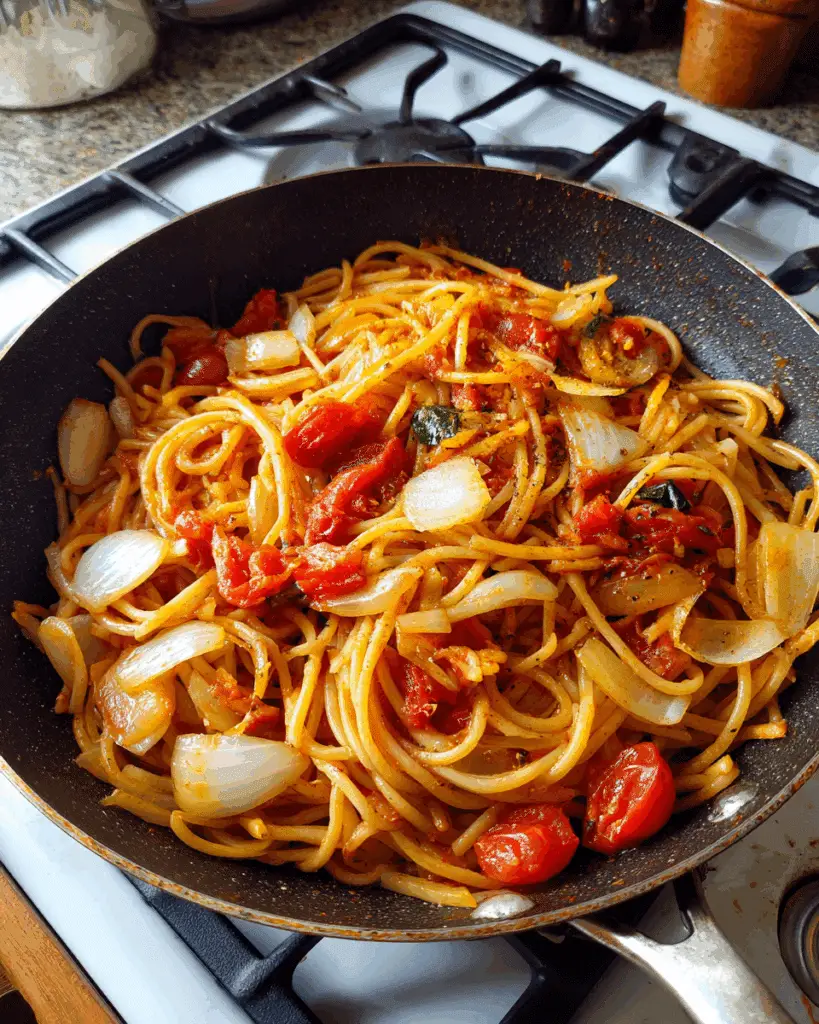 Tomato sauce for Pasta alla Sorrentina simmering in skillet