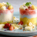 anti-inflammatory pineapple smoothie in layers with yogurt topping