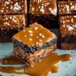 Pretzel Bottom Caramel Brownies stacked with dripping caramel
