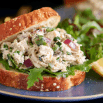 Fresh Tarragon Chicken Salad Sandwich on rustic bread with grapes.