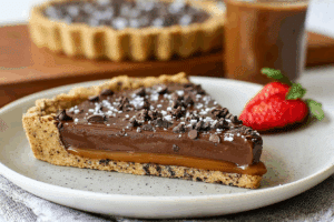 Chocolate Chip Salted Caramel Tart slice showing caramel and chocolate layers