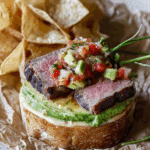 Carne Asada Torta with Roasted Poblano Salsa on a cutting board