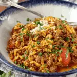 Manestra Greek-Style Orzo with Ground Beef in rustic bowl
