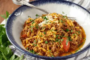 Manestra Greek-Style Orzo with Ground Beef in rustic bowl