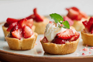 Overhead view of strawberry shortcake cookie cups on a rustic table