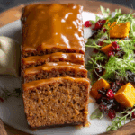 Moist brown sugar pumpkin loaf with glaze and fall decor