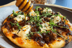 Sausage Ricotta Honey Hot Pizza with hot honey drizzle and basil