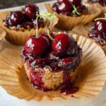 Homemade peanut butter cherry chia jam cups on a wooden table