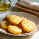 Golden French Butter Cookies on a plate with tea