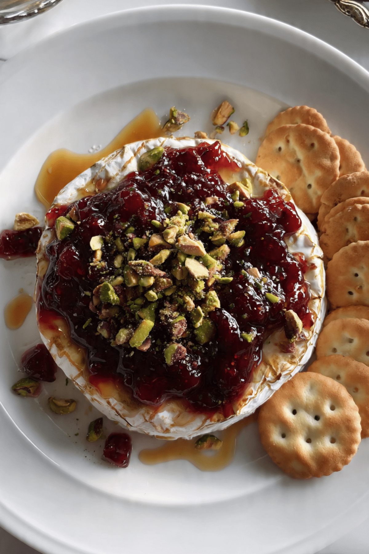 Baked Brie with Cherry Jam, Pistachios, Cinnamon, & Honey