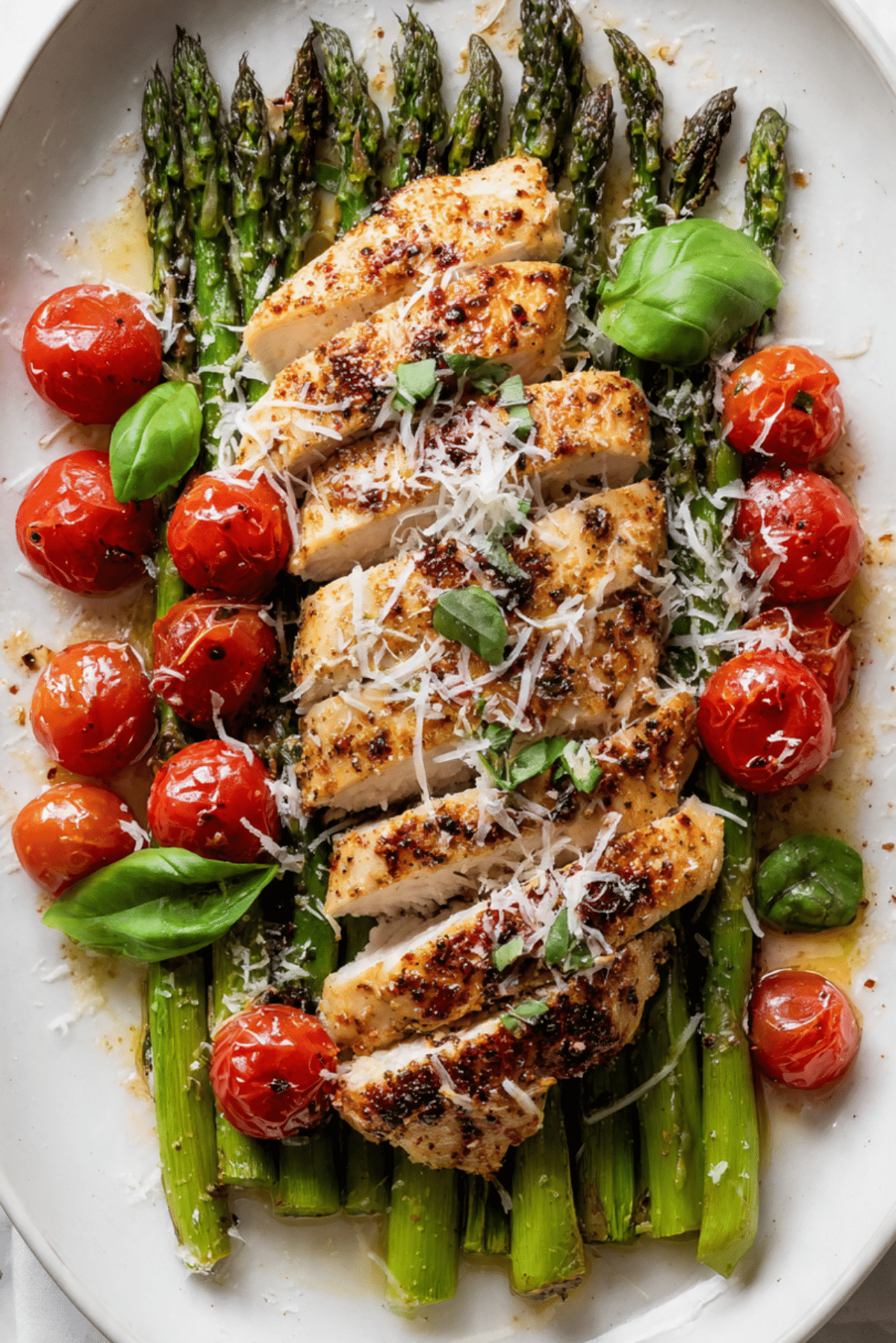 Juicy Flavor Packed Chicken Breast over Asparagus with Grape Tomatoes and Parmigiano Reggiano